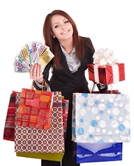 Woman holding money, gift box and shopping bag.
